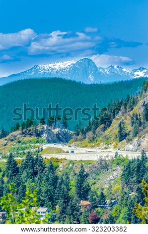 Landscape of British Columbia. Nice and comfortable great neighborhood. Some homes  and mountain road in the suburbs of Vancouver, Canada. Vertical.
