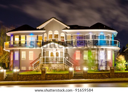 Luxury home exterior in the night time with the lights