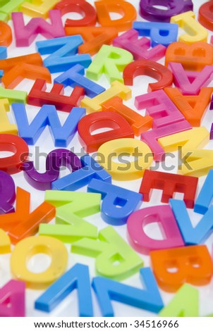 Brightly Colored Childrens Toy Magnetic Alphabet Letters on White Background