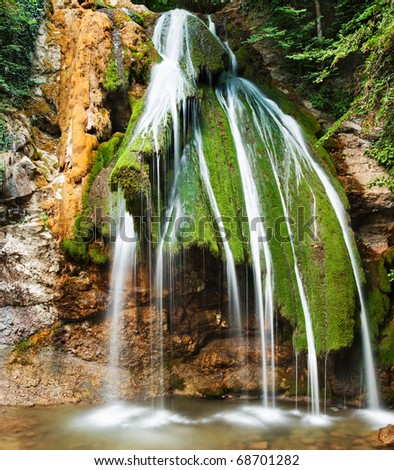 Beautiful waterfall in mountain wood, long exposure