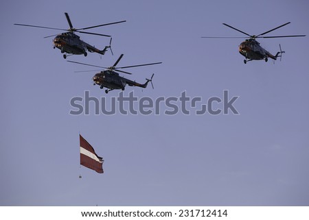 Military helicopters  from forces of NATO at military parade in Latvia at november 18, 2014 with Latvian flag.