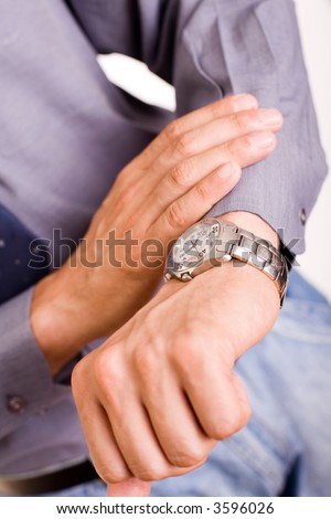 businessman looking at the watch, high key, focus on the watch