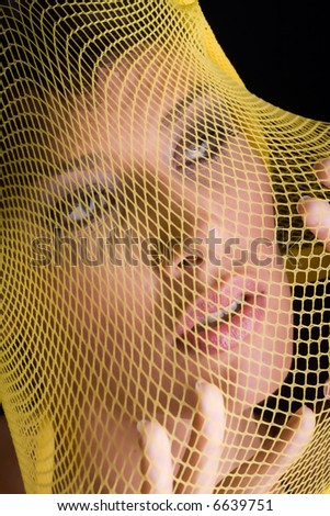 beautiful woman trapped in a net, could be used as women abuse concept