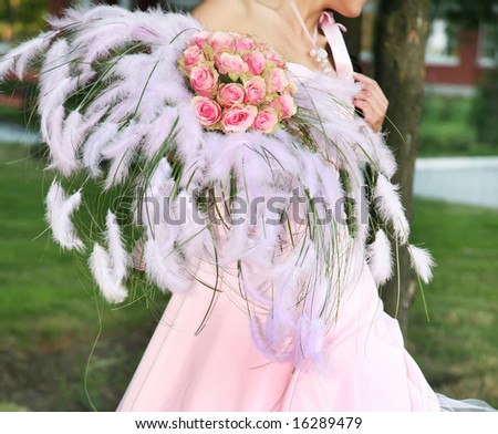 bride is holding flower bouquet at the wedding reception