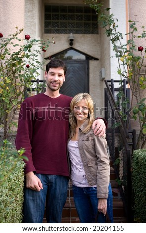 couple in front of a new home