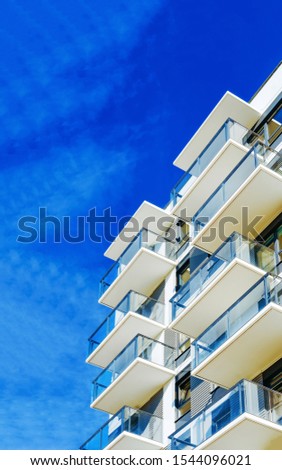 Detail in Modern residential flat and apartment building exterior. Fragment of New luxury house and home complex. Part of City Real estate property and condo architecture. Copy space. Blue sky Stock foto © 