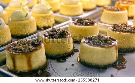 Cheesecake with nuts  and liquid caramel on the bakery storefront with blurred background