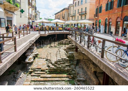 VERONA, ITALY - AUGUST 27, 2013: Street in center of city of Verona  with archeological dig site of antique Roman period
