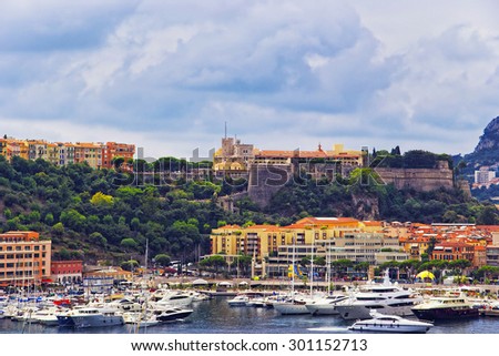 Port Hercule harbor, luxury ships and yachts and Palace of Prince of Monaco on the mountain in the Monaco (Monte Carlo) in summer