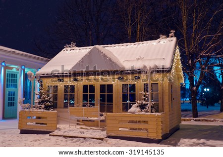 Wooden house decorated for Christmas, shining in the romantic atmosphere