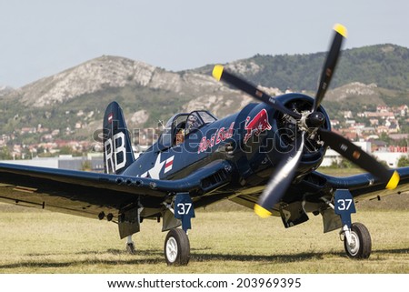 BUDAPEST, HUNGARY - MAY 1: Corsair historic  fighter bomber plane fly-by with Red Bull marking on it\'s fuselage on May1, 2014 in Hungary