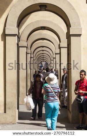 FLORENCE, ITALY - MAY 20, 2014: Tourists and locals alike visit historic center in Florence, Italy. Florence is home to some of the most famous works of art on earth.