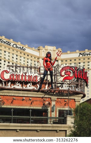 LAS VEGAS, NEVADA, USA - JULY 12, 2015 : A devil girl statue stands on the top of Diablo\'s Cantina in front of the Monte Carlo in Las Vegas. About 40 million people visiting the city each year.