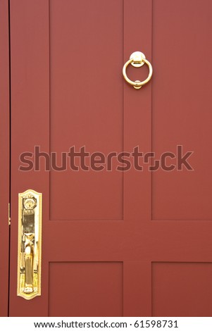Burgundy colored door with brass handle and knocker