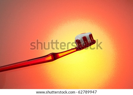 Red tooth brush with tooth paste