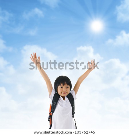 7 years old pan Asian school girl arms up in the air