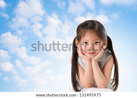 Young Asian girl with smile on her face sitting outdoor in summer day, blue sky background