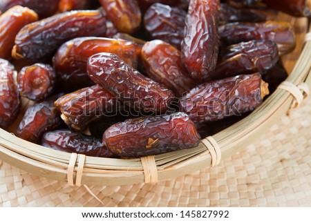 Dates fruit. Pile of fresh dried date fruits in a basket.