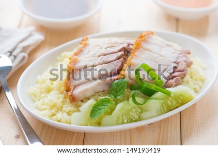 Siu Yuk or sliced Chinese boneless roast pork with crispy skin, serve with steamed rice. Hong Kong Chinese cuisine.
