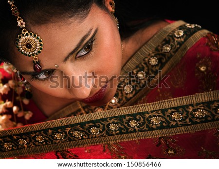 Close up face of attractive young Indian woman in traditional sari dress
