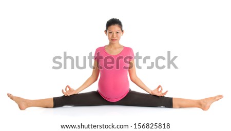 Pregnancy yoga class. Full length healthy Asian pregnant woman doing yoga exercise stretching, full body isolated on white background. Yoga seated positions.