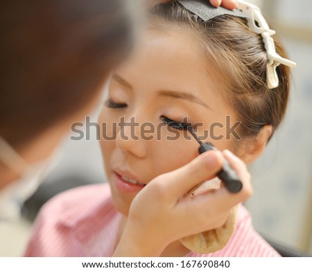 Asian Chinese bridal make up candid shoot. Wedding makeover preparation.