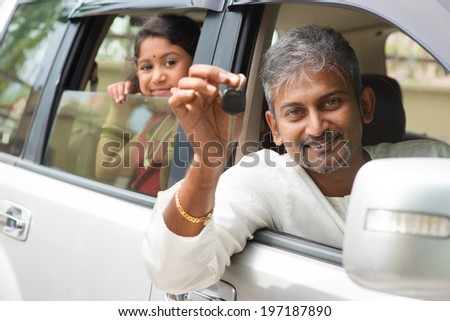 Indian man buying new car and showing the key, sitting in car. Asian family lifestyle.