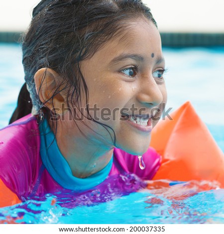 Indian Girl Learning Swimming In Pool Asian Child Swimmer Class With Float Bands Indian Girl Learning Swimming In Pool Asian Child Swimmer Class With Float Bands