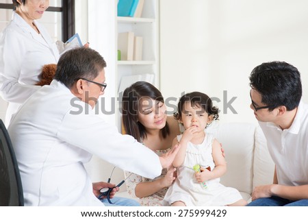 Toddler cries when consult family doctor. Pediatrician and patient healthcare concept.
