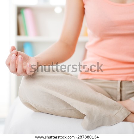 Meditation in the morning. Young woman indoors living lifestyle at home.