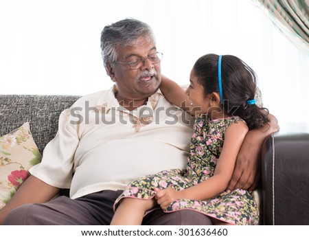 Portrait of Indian family at home. Grandparent and grandchild chatting. Asian people living lifestyle. Grandfather and granddaughter.