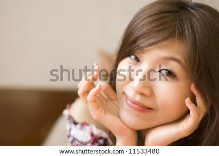 Young Asian women lying on bed with smiling face