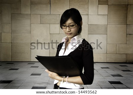 Young women holding a file, business/educational purpose.
