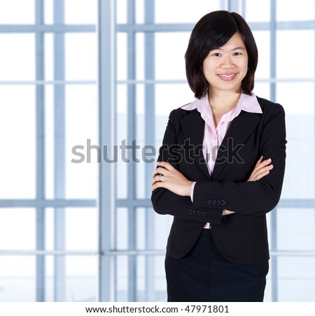 Asian business women standing in office.