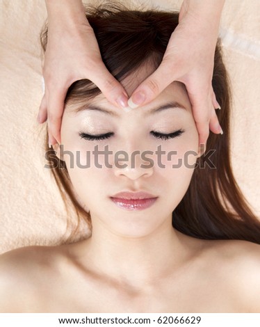 Beauty and Spa - Asian Girl having a massage on her head