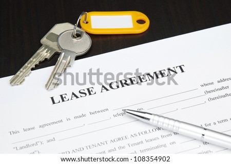 Lease agreement document with keys and pen