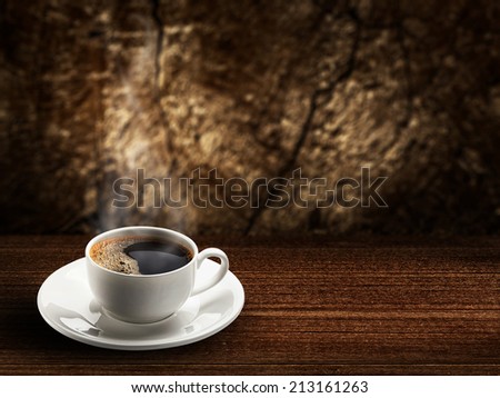 warm cup of coffee on brown wood background