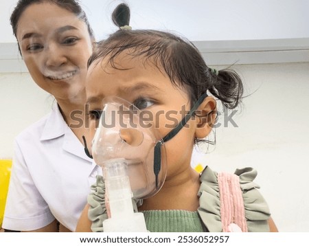 Similar – Image, Stock Photo Doctor applying a medicine during inhalation to senior man suffering from lung disease. Covid-19 or coronavirus treatment