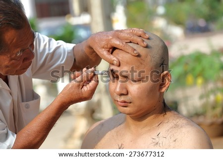 NAKHON RATCHASIMA, THAILAND-APRIL 12: Male who will be monk shaving hair for be Ordained to new monk on April 12, 2015 in the Chae Temple,Nakhon Ratchasima,Thailand