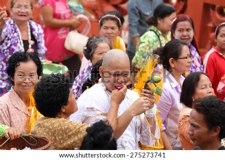 NAKHON RATCHASIMA , THAILAND - APRIL 12: Celebration of a new buddhist monk, new monks is thrown the money toward the many people for charity on April 12, 2015 in Nakhon Ratchasima , Thailand