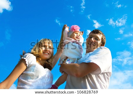 family with a child against the blue sky