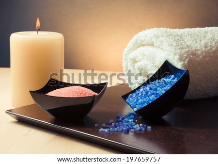 Spa massage border background with towel stacked, candle and sea salt, warm atmosphere