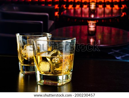 whiskey glasses with ice in a lounge bar on wood table