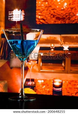 blue cocktail drink on a lounge bar table, club atmosphere