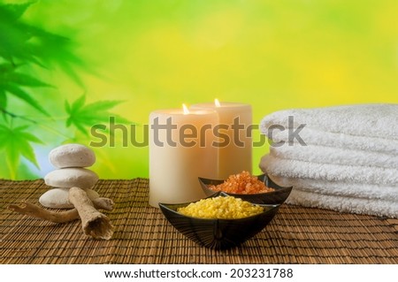 Spa massage border background with towel stacked, candle and sea salt, warm atmosphere