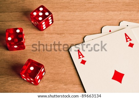 detail of red dice and cards on old wood