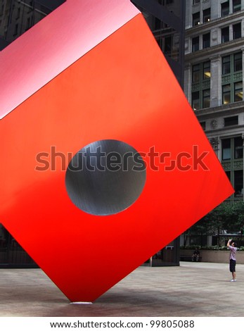 NEW YORK - JUN 20: Noguchi\'s Red Cube in front of the HSBC bank building on 20 June, 2011 in New York. This is the place, where the movement \