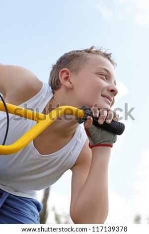 pretty guy on a bike outside in the summer day