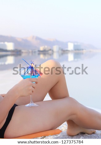 cocktail and a girl in the summer sea relax