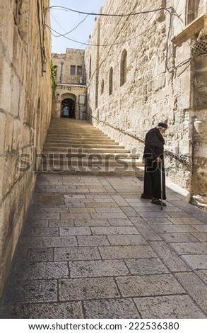 JERUSALEM/ISRAEL - 20 SEPTEMBER 2014: monk walking down the street of Old Jerusalem. 20 september 2014 Jerusalem.